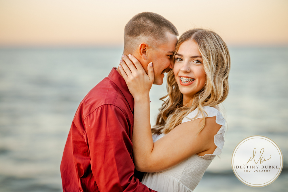 Surprise beach proposal at Durand Eastman Beach near Rochester, NY, captured by the best surprise proposal photographer near Rochester, NY during golden hour along Lake Ontario.