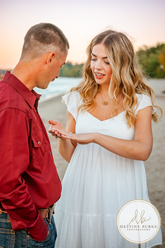 Surprise beach proposal at Durand Eastman Beach near Rochester, NY, captured by the best surprise proposal photographer near Rochester, NY during golden hour along Lake Ontario.