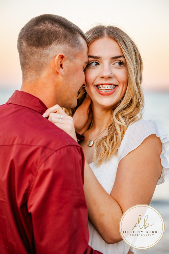 Surprise beach proposal at Durand Eastman Beach near Rochester, NY, captured by the best surprise proposal photographer near Rochester, NY during golden hour along Lake Ontario.