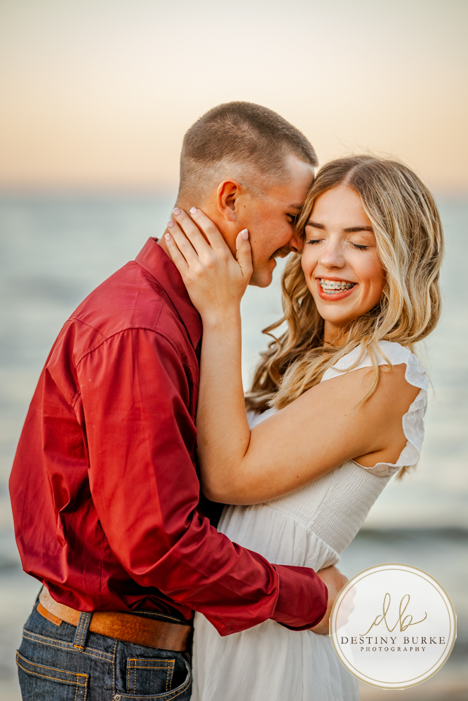 Surprise beach proposal at Durand Eastman Beach near Rochester, NY, captured by the best surprise proposal photographer near Rochester, NY during golden hour along Lake Ontario.