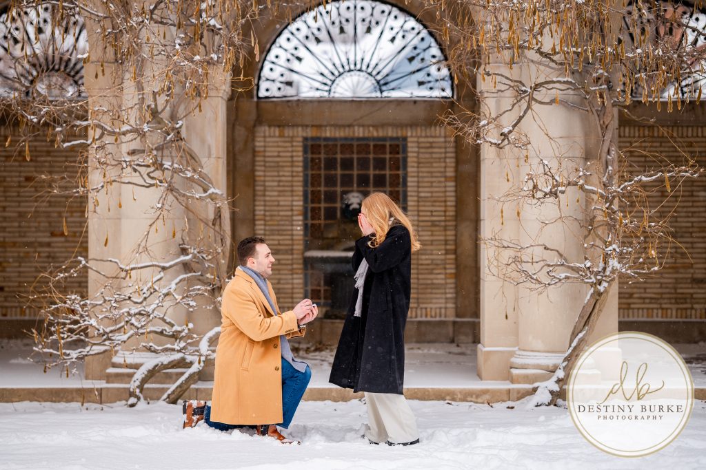 best surprise proposal photographer near rochester ny winter engagement at the George Eastman Museum, snowy portrait photoshoot