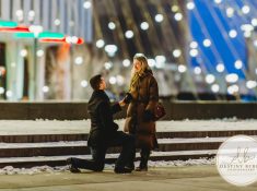 Romantic surprise proposal in Rochester, NY with refined winter city lights, capturing a once-in-a-lifetime moment for a couple beginning their forever together.