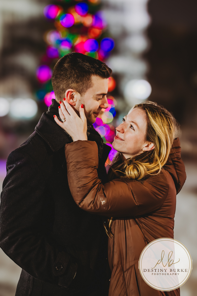 Romantic surprise proposal in Rochester, NY with refined winter city lights, capturing a once-in-a-lifetime moment for a couple beginning their forever together.