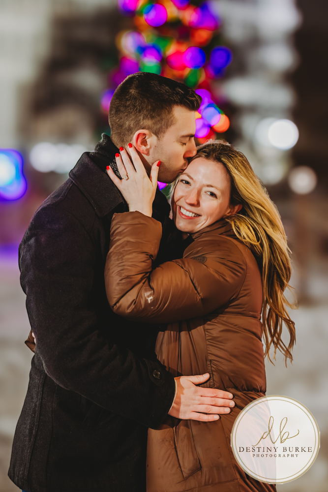 Romantic surprise proposal in Rochester, NY with refined winter city lights, capturing a once-in-a-lifetime moment for a couple beginning their forever together.