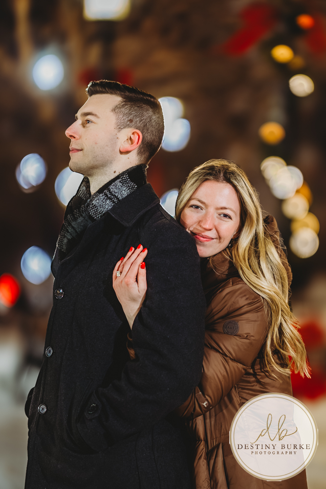 Discreetly photographed surprise proposal at the Liberty Pole in Rochester, NY designed for clients seeking a seamless, stress-free luxury engagement experience.